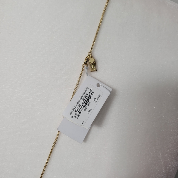 Kate Spade gold tone necklace with shiny bow charm - Picture 2 of 4